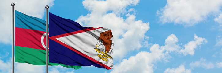 Azerbaijan and American Samoa flag waving in the wind against white cloudy blue sky together....
