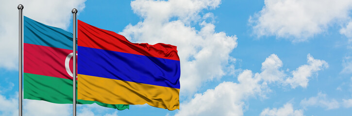 Azerbaijan and Armenia flag waving in the wind against white cloudy blue sky together. Diplomacy concept, international relations.