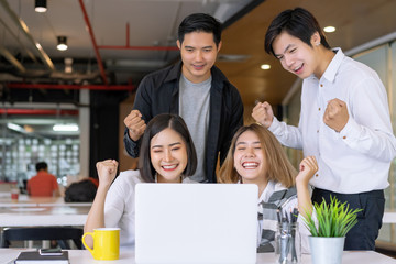 Portrait of successful startup business team. Diverse business people standing together happy and excited doing winner gesture with arms raised, smiling and screaming for success.