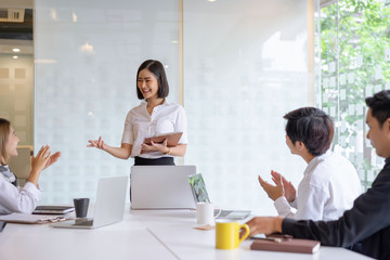 Female startup business coach making presentation to office workers at meeting, giving recommendations, advise to run startup business, discussion, workshop.