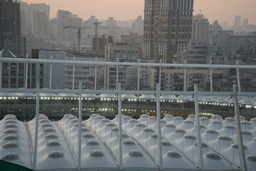 Roof of stadium and cityscape behind on city background. Soccer stadium