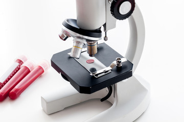 Blood testing. Samples viewing under microscope on white background top view space for text