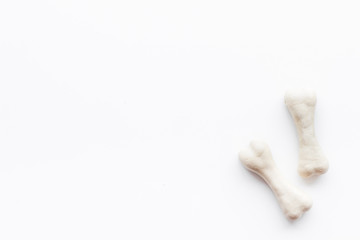 Treats for dogs. Chewing bones on white background top view copy space