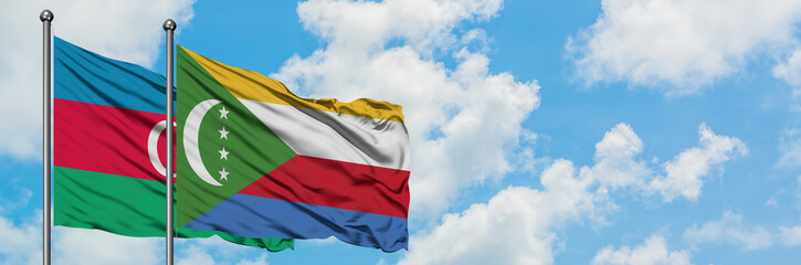 Azerbaijan and Comoros flag waving in the wind against white cloudy blue sky together. Diplomacy...