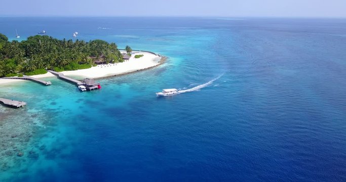 Luxurious yacht boat off the coast of luscious island in the Bahamas