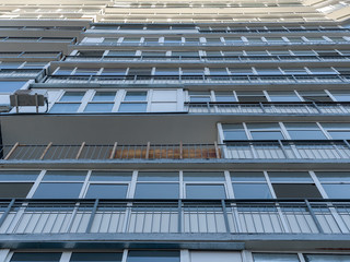 Bottom view of a new house. Lines of windows and balconies. The theme of an emerging housing market...