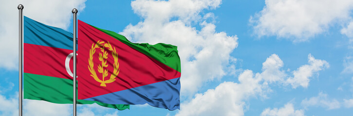 Azerbaijan and Eritrea flag waving in the wind against white cloudy blue sky together. Diplomacy concept, international relations.
