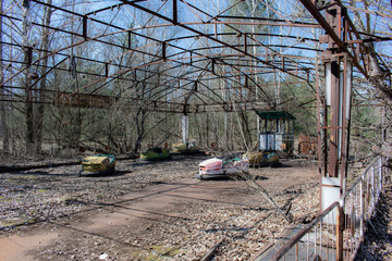 abandoned bumper cars in ruined amusement park in Pripyat city, Exclusion zone of Chernobyl