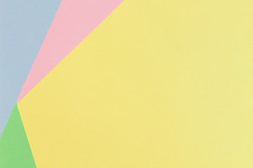 Abstract geometric paper background in light pastel yellow, blue, green, pink color tones