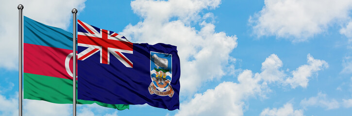 Azerbaijan and Falkland Islands flag waving in the wind against white cloudy blue sky together. Diplomacy concept, international relations.
