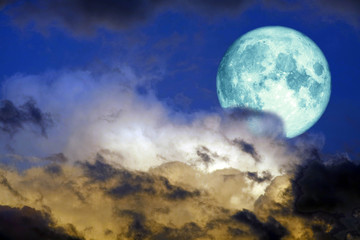 Fototapeta na wymiar super full harvest blue moon back on silhouette cloud on sunset sky