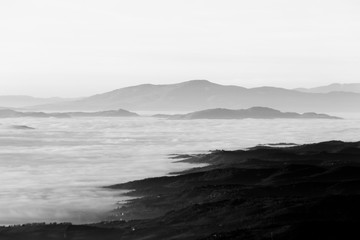 A view of Umbria valley with hills and fog