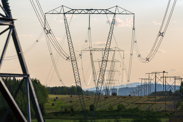 High voltage power lines draped over farm fields