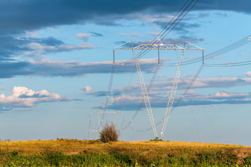 High voltage power lines and towers cross the countryside