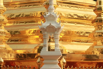 Fototapeta premium architectural details and carvings at an ancient teak timber Thai Buddhist temple in Northern Thailand showing traditional patterns and designs of a religious building, Southeast Asia