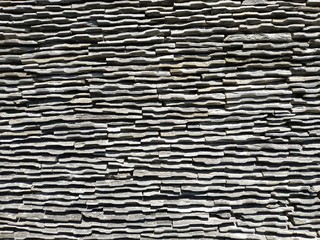 Closeup detail of chipped slate stone decorative wall