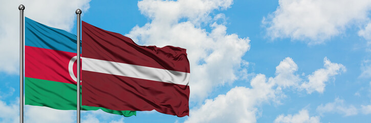 Fototapeta na wymiar Azerbaijan and Latvia flag waving in the wind against white cloudy blue sky together. Diplomacy concept, international relations.