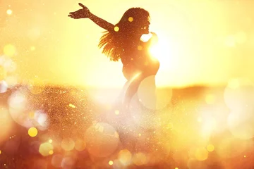 Foto auf Acrylglas Young woman on field under sunset light © BillionPhotos.com