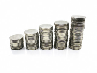 Silver coins stacked over white background.