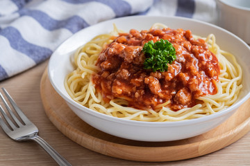 Spaghetti bolognese in white bowl