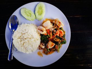 Stir Fried Basil with Seafood on white dish. Key ingredient  squid, shrimp and Mussels.