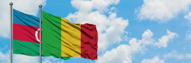 Obraz premium Azerbaijan and Mali flag waving in the wind against white cloudy blue sky together. Diplomacy concept, international relations.