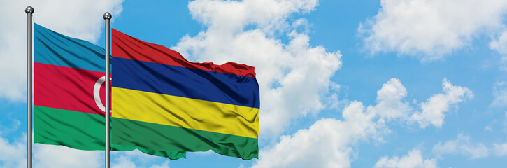 Azerbaijan and Mauritius flag waving in the wind against white cloudy blue sky together. Diplomacy concept, international relations.
