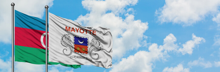 Azerbaijan and Mayotte flag waving in the wind against white cloudy blue sky together. Diplomacy concept, international relations.