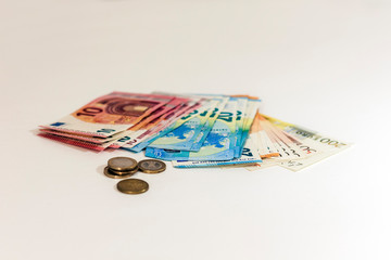 Close up money euro banknotes and coins on white background.