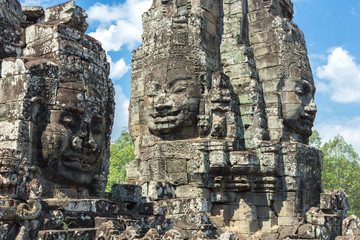 Faces carved in stone in Bayon temple towers, Angkor Wat complex, Cambodia, Siem Reap