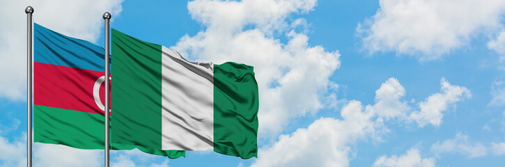 Azerbaijan and Nigeria flag waving in the wind against white cloudy blue sky together. Diplomacy concept, international relations.
