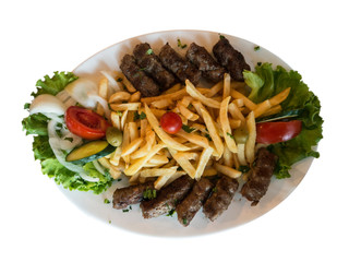 Fried small meat cutlet on white ceramic plate top view isolated