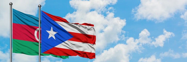 Azerbaijan and Puerto Rico flag waving in the wind against white cloudy blue sky together. Diplomacy concept, international relations.