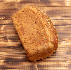 Fresh wheat bread on a wooden background