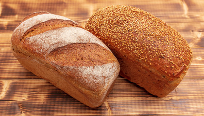 Fresh wheat bread on a wooden background