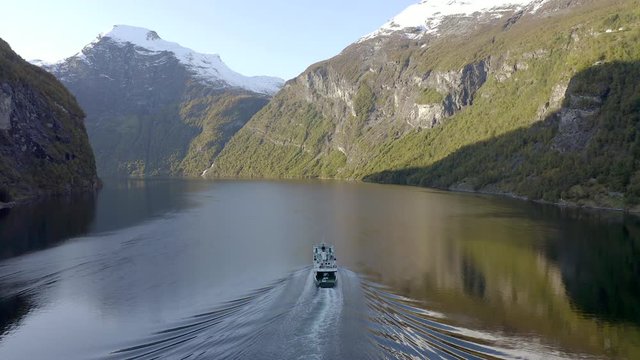 Ferry Passing Through a Fjord in Norway During the Fall