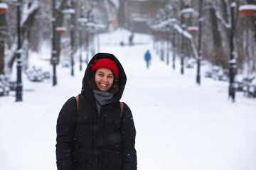 Fototapeta na wymiar smiling woman portrait in winter outfit at city park