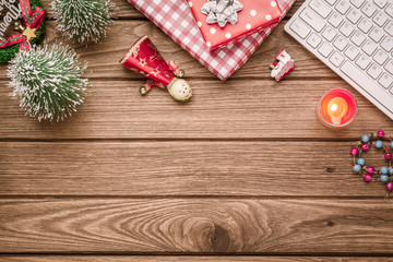 Merry Christmas and Happy new years office work space desktop concept. Flat lay top view with keyboard, blank notebook and Christmas ornaments with copy space.