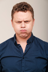 Obraz premium Studio portrait of grumpy man 