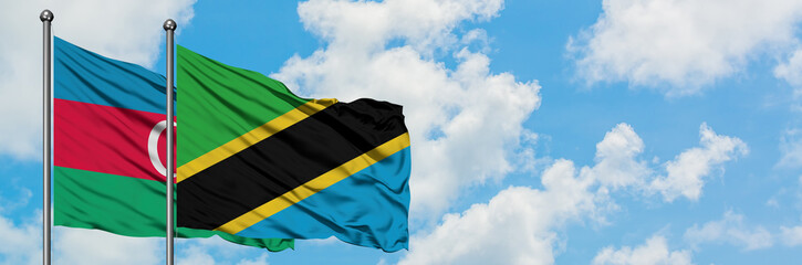 Azerbaijan and Tanzania flag waving in the wind against white cloudy blue sky together. Diplomacy concept, international relations.