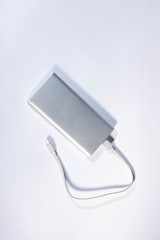 Power bank for charging mobile devices. White smart phone charger with power bank. battery bank. External battery for mobile devices.