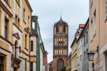 Traditional colorful houses and church tower in the old town of Stralsund