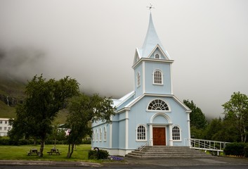 Light blue wooden church Seydisfjardarkirkja in Seydisfjordur, Iceland