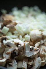 сooking onions and mushrooms on wok pan