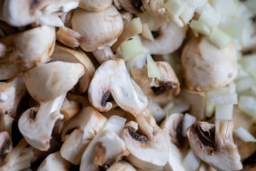 сooking onions and mushrooms on wok pan