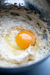 Broken egg and flour in a bowl. Food preparation concept