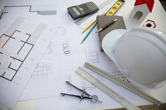 Desk of Architectural working project in construction site,With drawing equipment concept