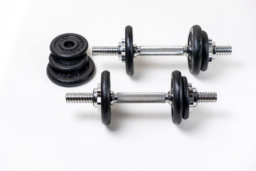 Obraz na płótnie Canvas Sports dumbbells with removable weights on a white background