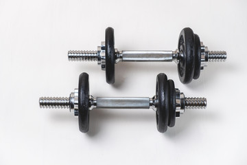 Sports dumbbells with removable weights on a white background