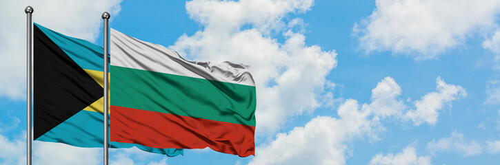 Obraz premium Bahamas and Bulgaria flag waving in the wind against white cloudy blue sky together. Diplomacy concept, international relations.